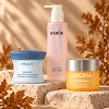 Three skincare products for a morning routine in an autumn setting